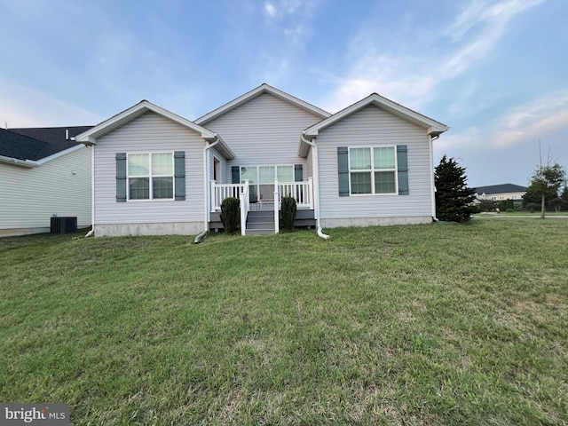 view of front of house with a front lawn and central air condition unit