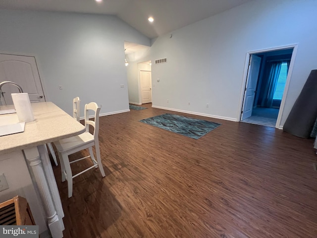 interior space featuring dark hardwood / wood-style flooring and lofted ceiling