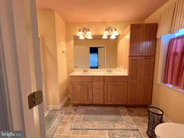 bathroom featuring vanity and a notable chandelier