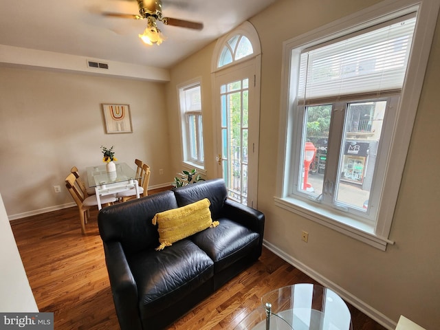 living room with hardwood / wood-style flooring and ceiling fan