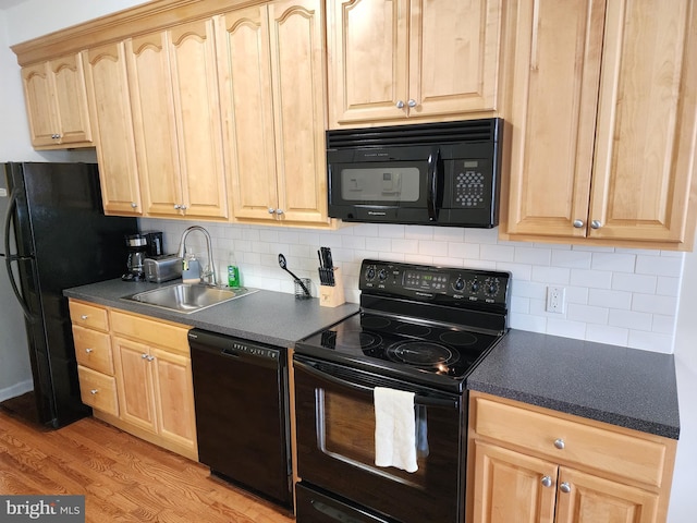 kitchen with black appliances, light brown cabinetry, light wood-type flooring, sink, and backsplash