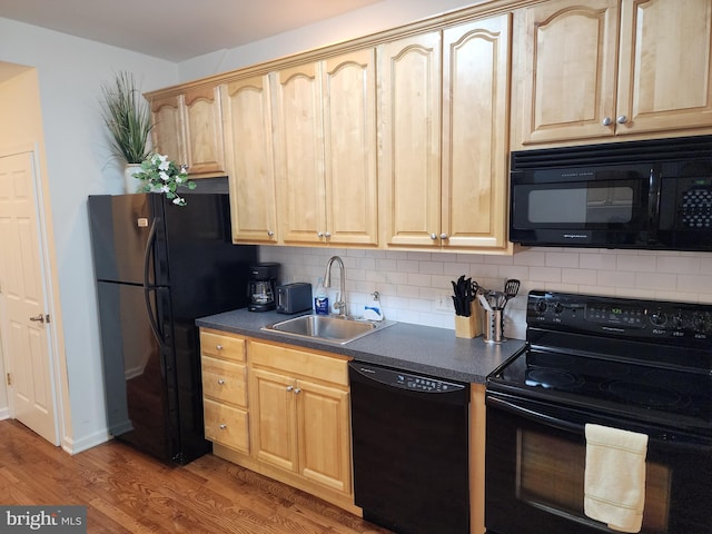 kitchen with black appliances, light brown cabinetry, hardwood / wood-style flooring, tasteful backsplash, and sink