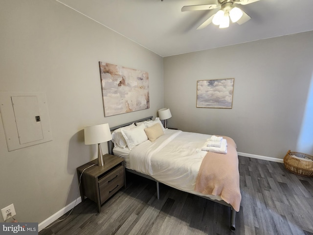 bedroom with dark hardwood / wood-style flooring, electric panel, and ceiling fan