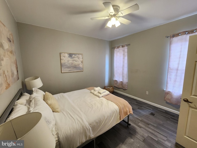 bedroom with ceiling fan and dark hardwood / wood-style flooring