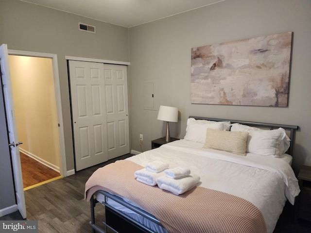 bedroom featuring dark hardwood / wood-style floors and a closet