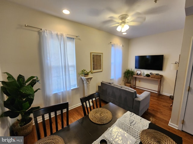 dining space with dark hardwood / wood-style floors and ceiling fan