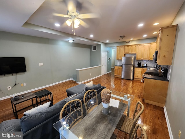 living room featuring hardwood / wood-style flooring and ceiling fan