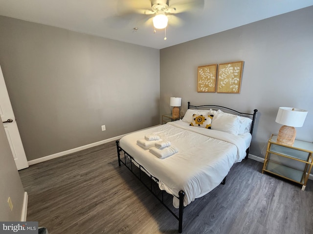 bedroom with dark hardwood / wood-style flooring and ceiling fan