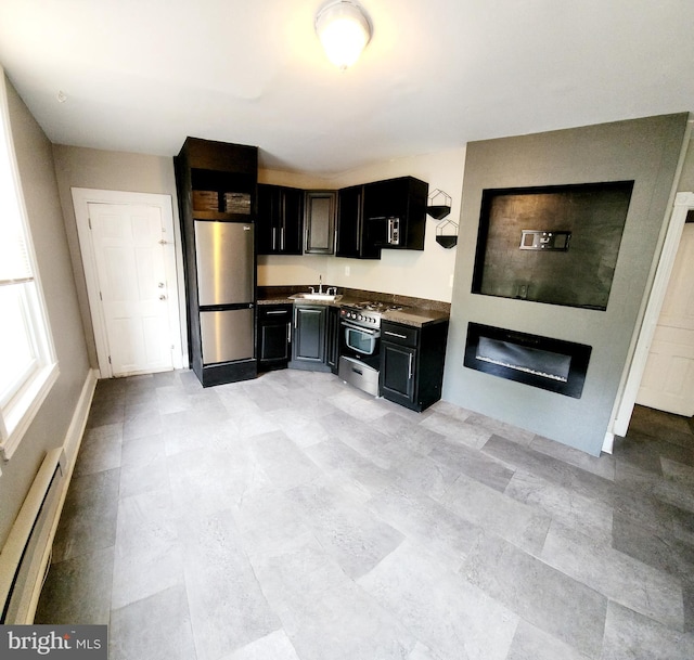 kitchen featuring appliances with stainless steel finishes, a baseboard radiator, and sink