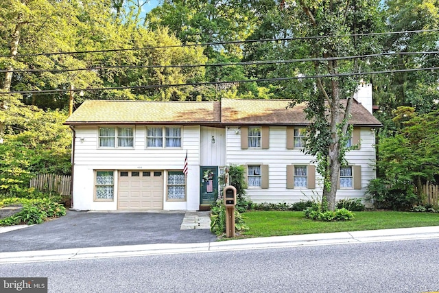 view of front of house with a front lawn and a garage