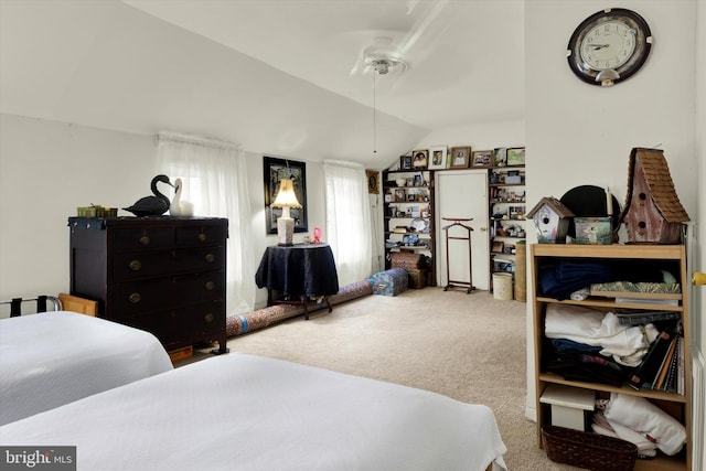 carpeted bedroom with ceiling fan and lofted ceiling