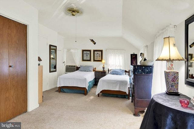 bedroom with vaulted ceiling, a closet, and carpet