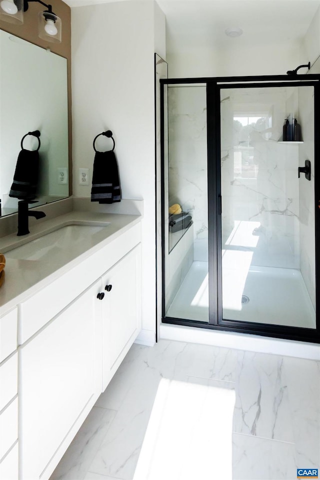 bathroom featuring vanity and an enclosed shower