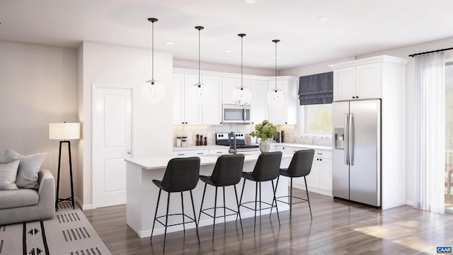 kitchen with white cabinetry, backsplash, pendant lighting, a kitchen island with sink, and appliances with stainless steel finishes