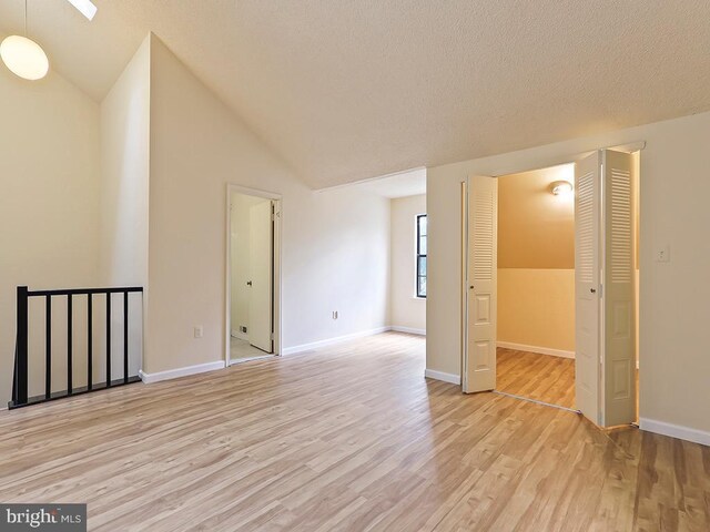 interior space featuring light hardwood / wood-style floors and lofted ceiling