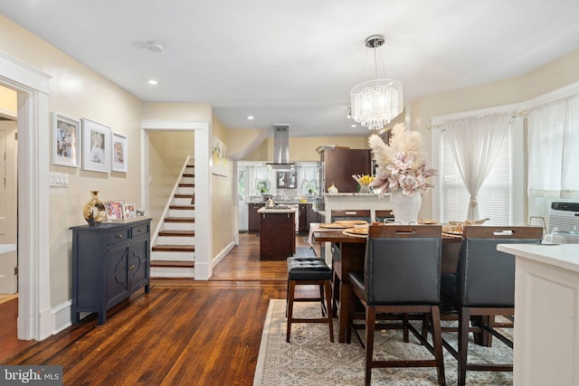 dining space with an inviting chandelier and dark hardwood / wood-style floors