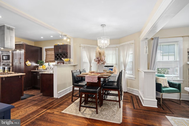 dining space featuring dark hardwood / wood-style flooring and a notable chandelier