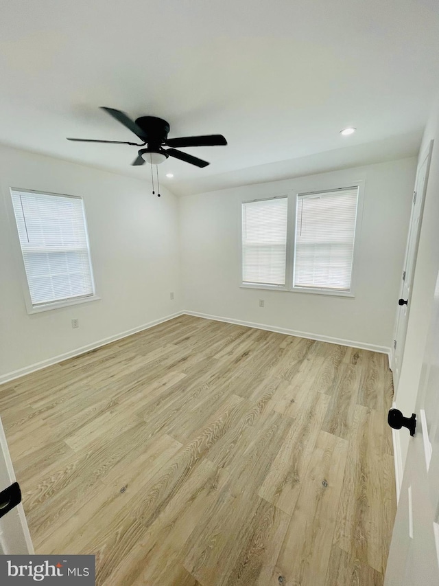 spare room with light hardwood / wood-style flooring and ceiling fan