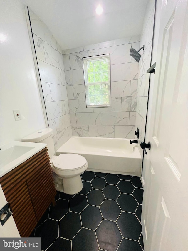 full bathroom with vanity, tile patterned flooring, tiled shower / bath, and toilet