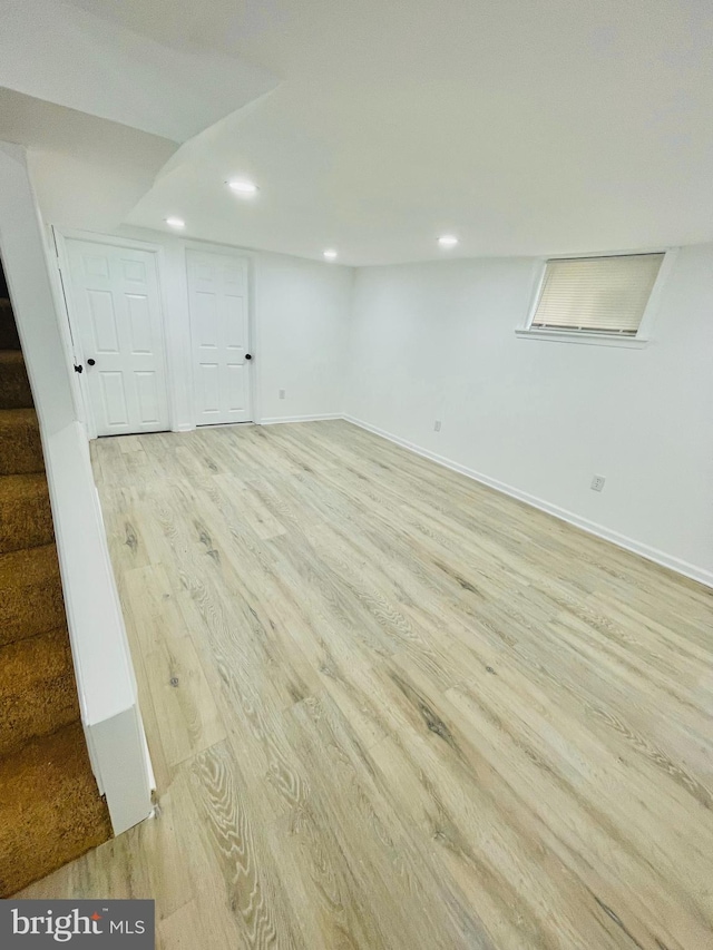 basement with light hardwood / wood-style floors