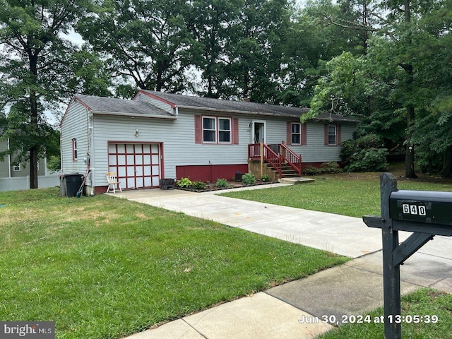 split foyer home featuring a garage and a front lawn