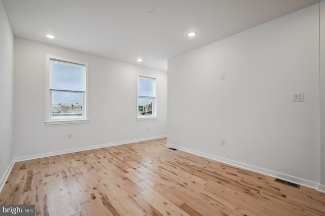 empty room with light hardwood / wood-style floors