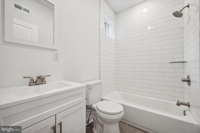 full bathroom with toilet, tiled shower / bath, and vanity