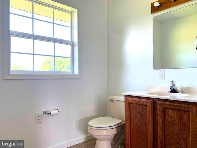 bathroom with vanity, tile patterned floors, and toilet