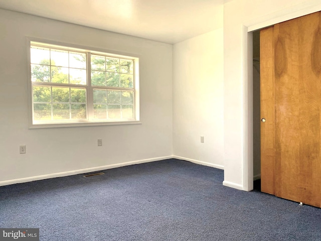 interior space with dark colored carpet