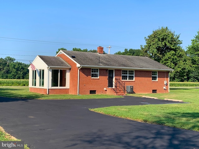 single story home with central AC unit and a front yard