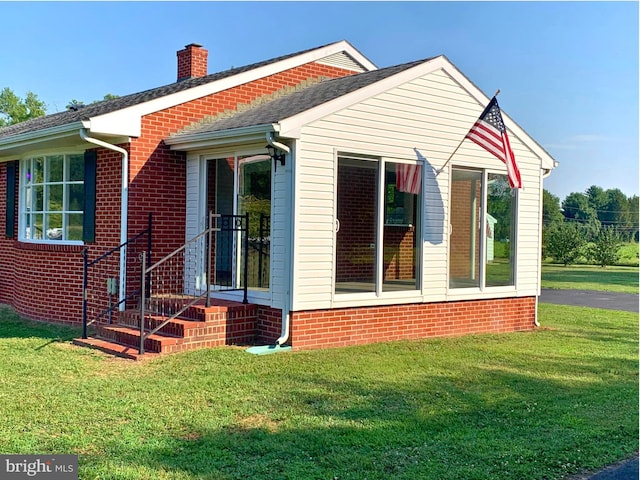 view of home's exterior with a yard