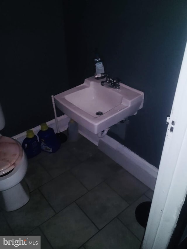 bathroom featuring tile patterned floors, toilet, and sink