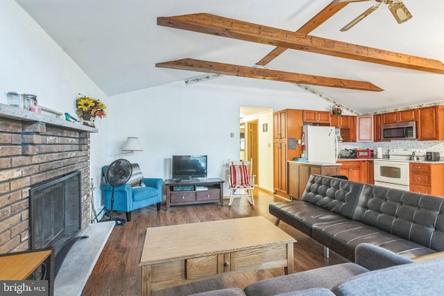 living room featuring vaulted ceiling with beams, a brick fireplace, ceiling fan, and dark wood-type flooring