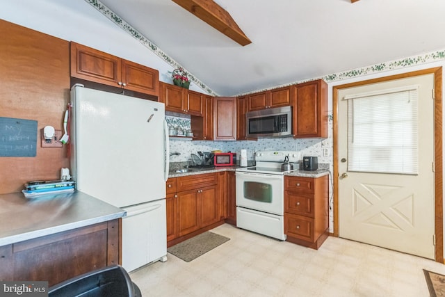 kitchen featuring lofted ceiling and white appliances