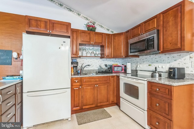 kitchen with lofted ceiling, decorative backsplash, white appliances, and sink