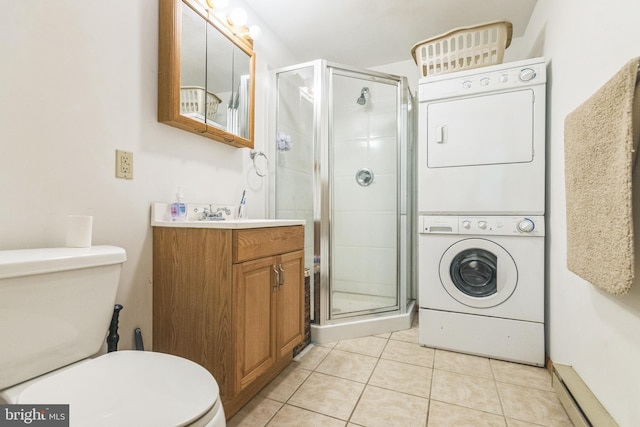 interior space featuring tile patterned flooring, a shower with shower door, stacked washer and clothes dryer, and toilet