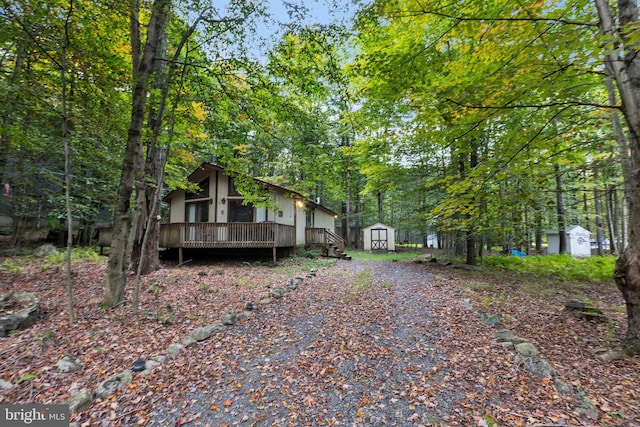 exterior space featuring a shed and a deck