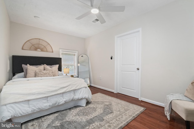 bedroom featuring ceiling fan and dark hardwood / wood-style floors