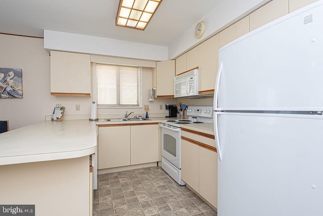 kitchen featuring kitchen peninsula, cream cabinets, white appliances, and sink