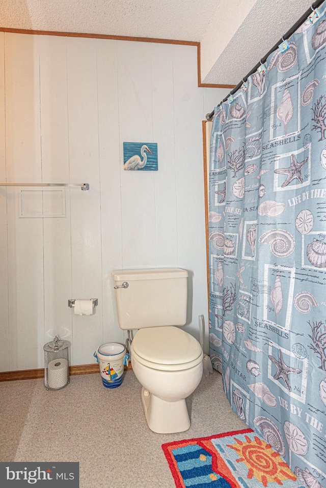 bathroom with a textured ceiling and toilet