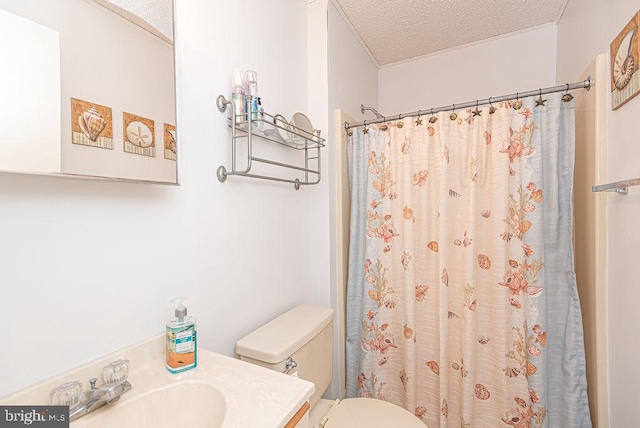 bathroom with a shower with curtain, vanity, toilet, and a textured ceiling