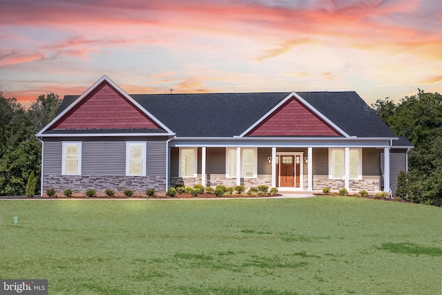 craftsman-style home featuring a porch and a yard