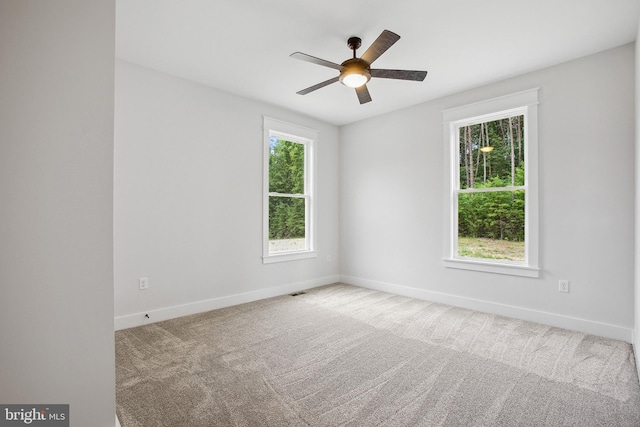 spare room featuring ceiling fan and carpet floors