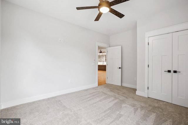 unfurnished bedroom featuring ceiling fan, carpet floors, and a closet