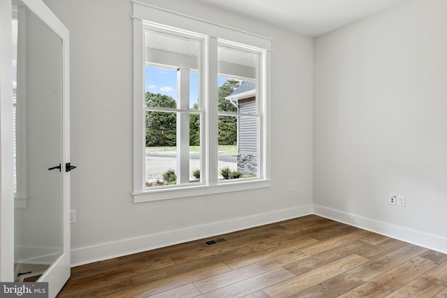 unfurnished room with light wood-type flooring