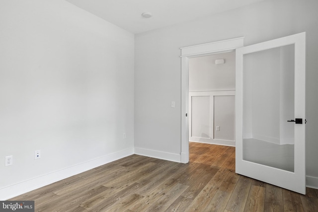 unfurnished room with hardwood / wood-style floors