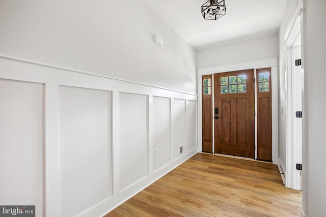 foyer featuring light hardwood / wood-style flooring and an inviting chandelier