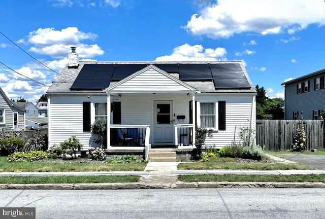 bungalow-style house featuring covered porch and solar panels