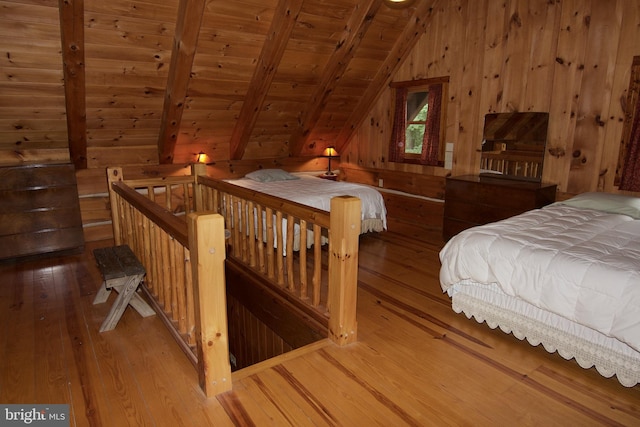 bedroom featuring hardwood / wood-style floors, wood ceiling, wooden walls, and lofted ceiling with beams