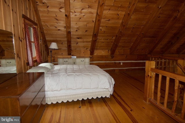 bedroom featuring vaulted ceiling with beams, wooden ceiling, wooden walls, and hardwood / wood-style flooring